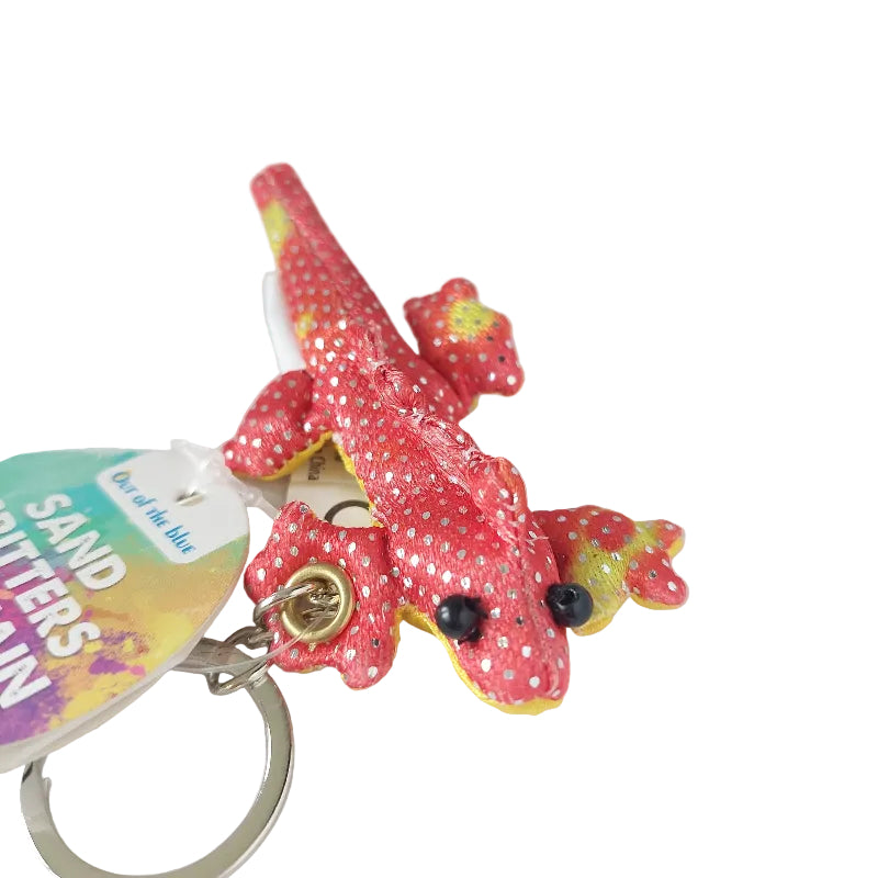 Rode zanddier sleutelhanger met stekels en voelbaar zand, compact sensorisch materiaal voor fijne motoriek, concentratie en zelfregulatie, bevestigd aan sleutelring.