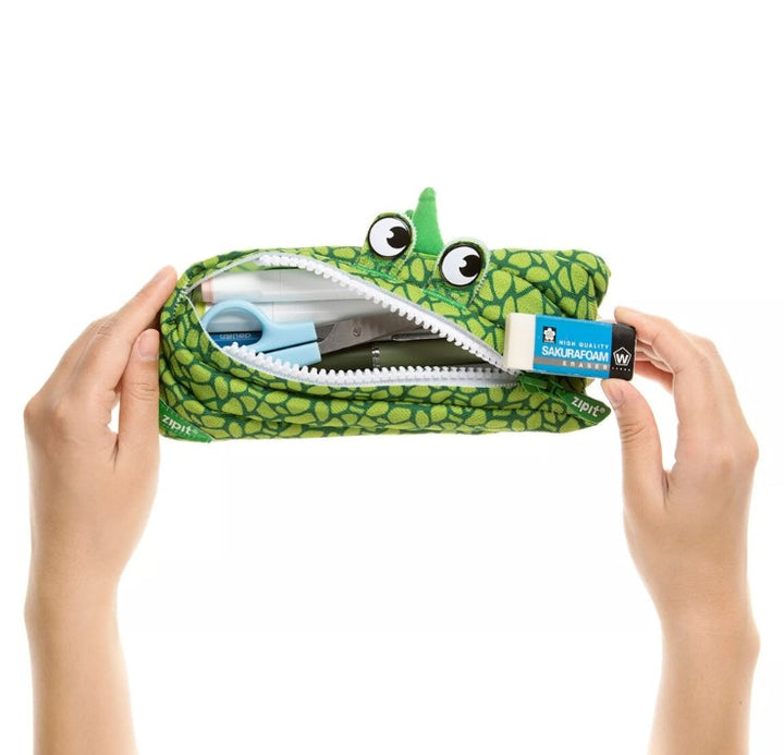 groen etui met grote ogen, handen en inhoud, ritsetui